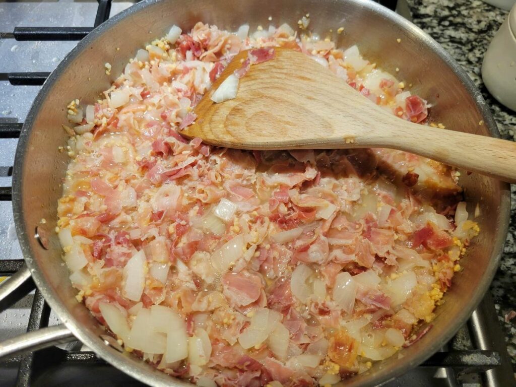 Panetta, garlic, and onion in a sauté pan.
