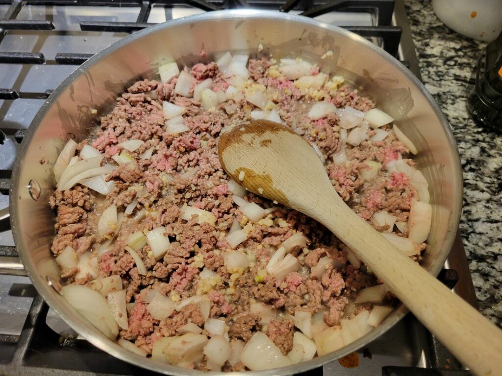 Ground beef with onions fried in a pan.