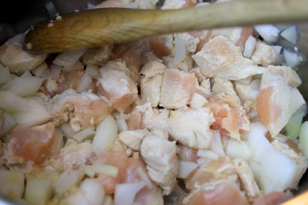 Chicken being cooked in a skillet.