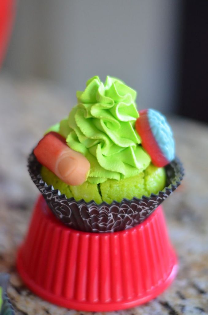Body Part Cupcakes from Mooshu Jenne. They feature body part gummies with a green whipped topping icing and a yogurt based cupcake.