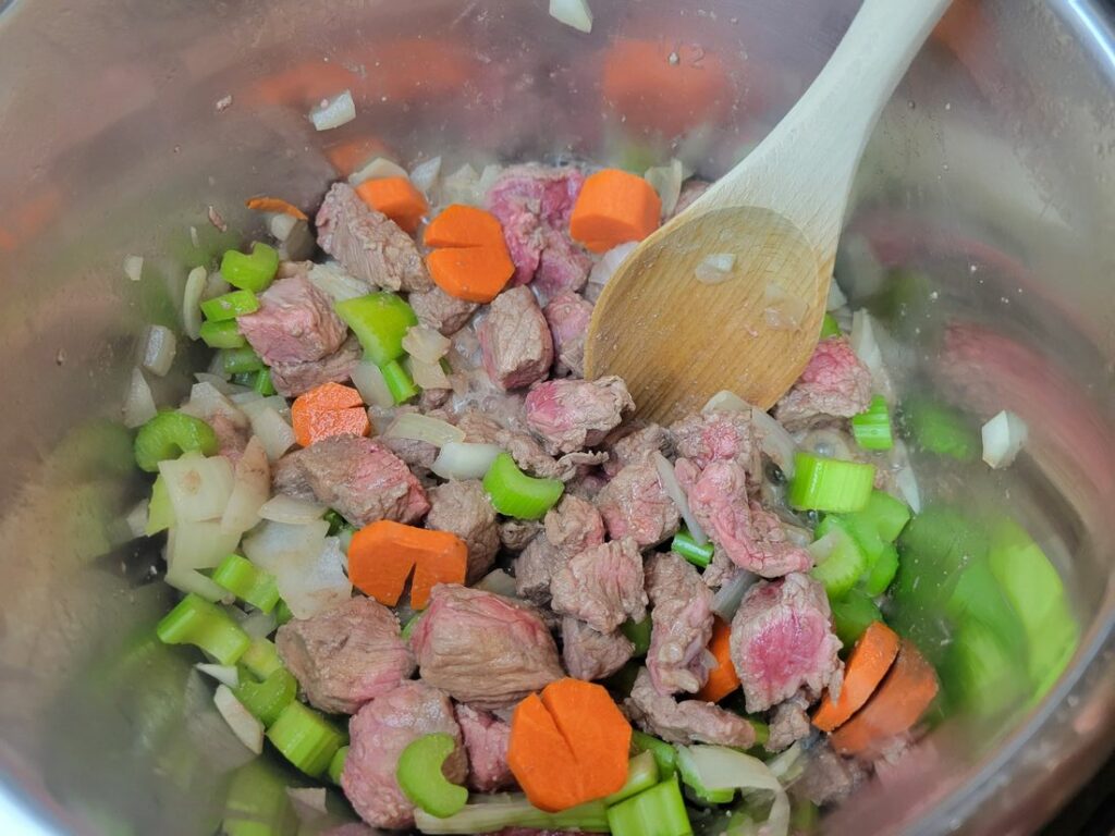 Beef, onion, carrots, and celery in the instant pot.