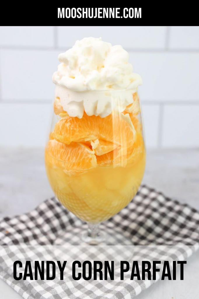 Pineapples, oranges, and whipped topping in a glass.