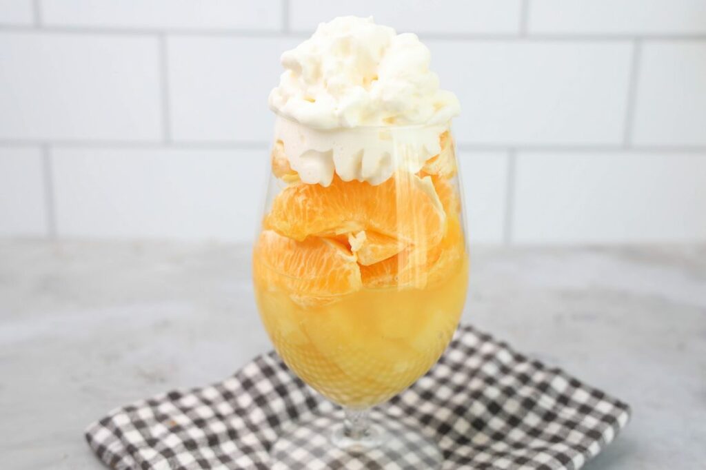 Candy corn parfait with pineapples, oranges and whipped topping.