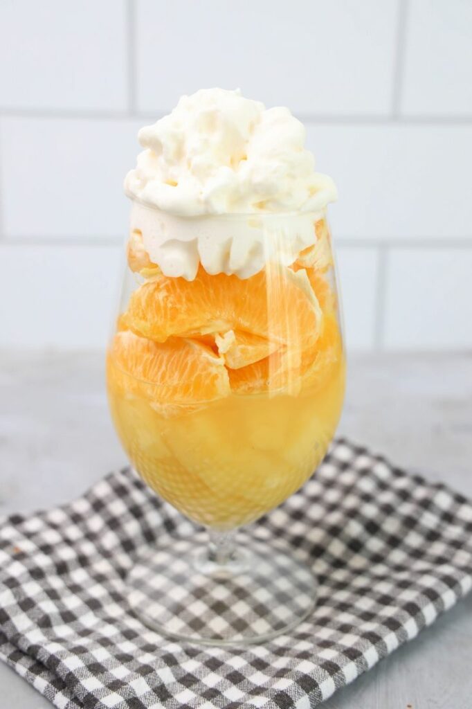 Candy corn parfait with pineapples, oranges and whipped topping.