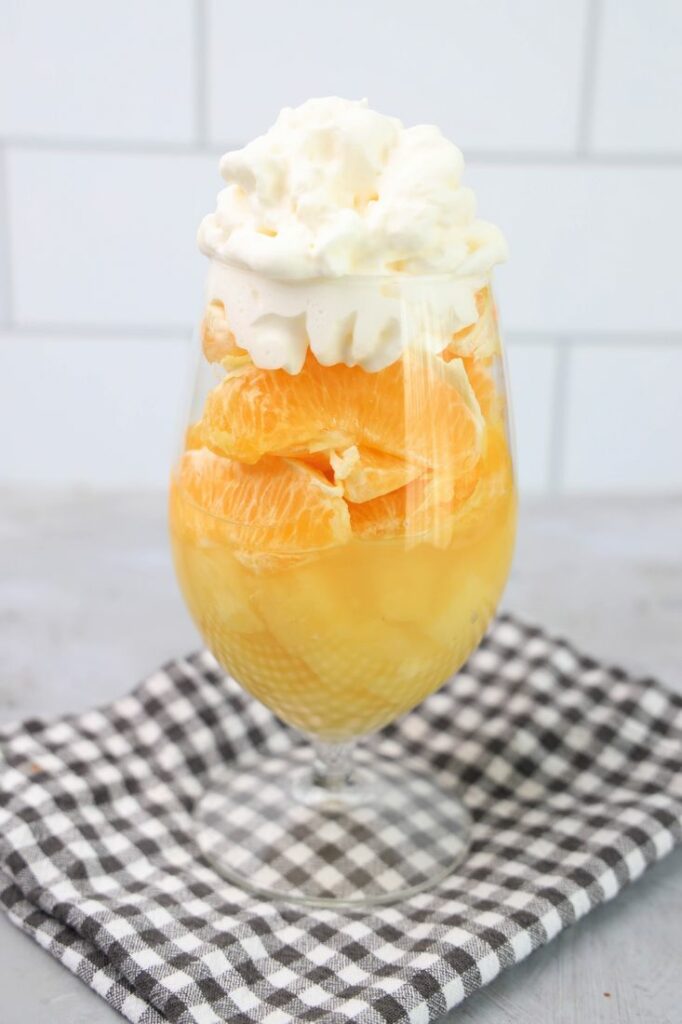 Candy corn parfait with pineapples, oranges and whipped topping.