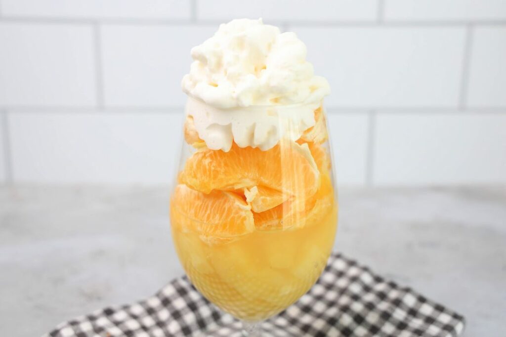 Candy corn parfait with pineapples, oranges and whipped topping.