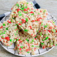 Rice Krispie Heart Holiday Treats made with Rice Kirispies Christmas cereal on a white and black plate.