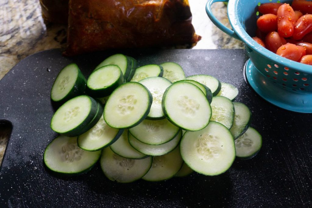 Sliced Cucumbers on black cutting board