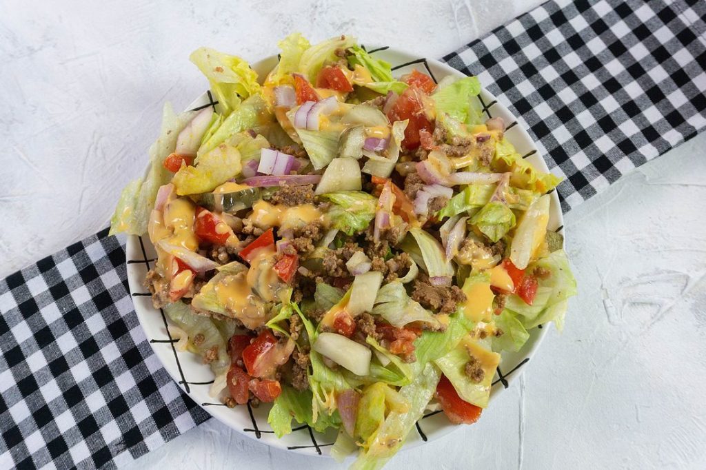 Big Mac Salad on white background with plaid napkin