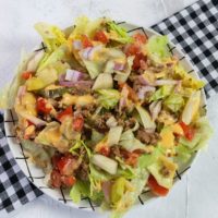 Big Mac Salad on white background with plaid napkin