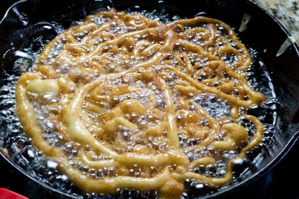 Funnel Cake in oil in cast iron skillet