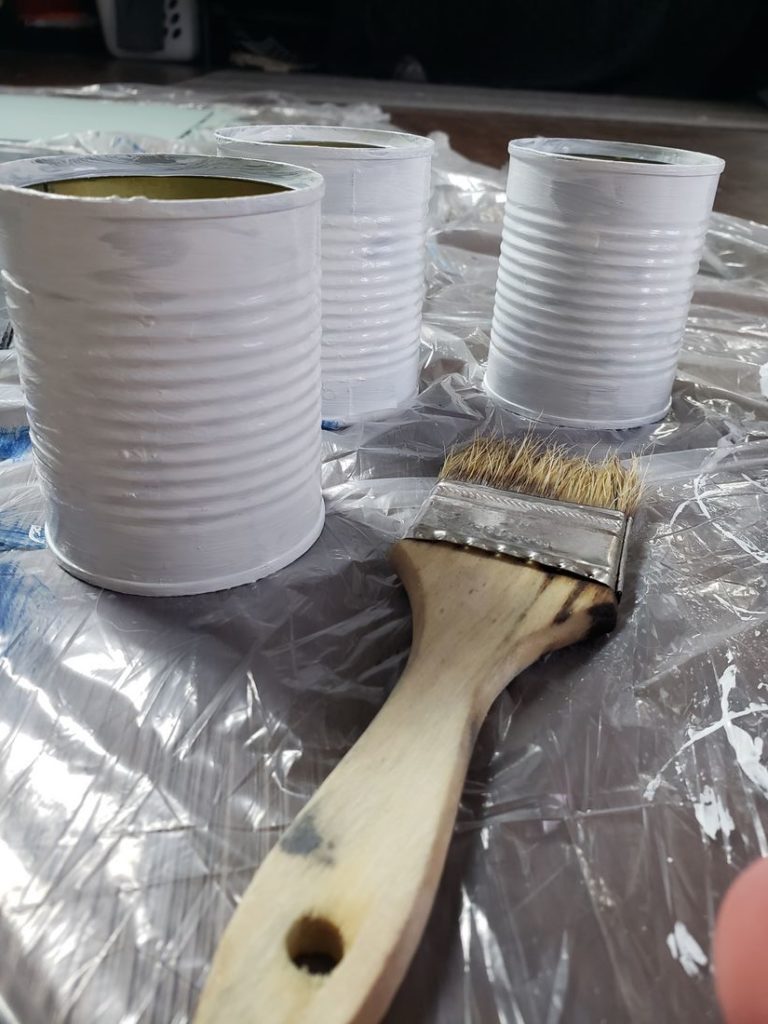 Tin planters with second coat of paint.