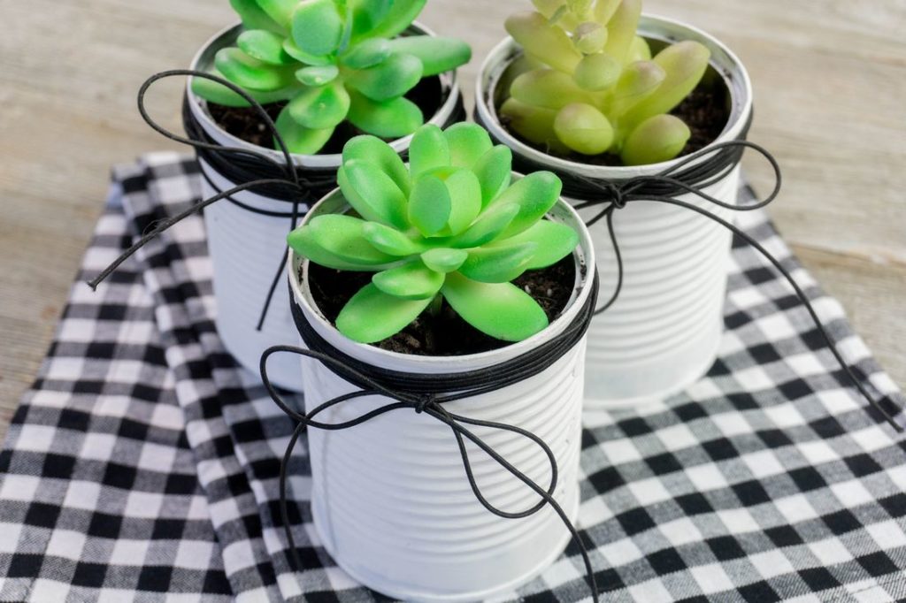 Farmohouse Tin Planters on black and white plaid napkin and gray wood.