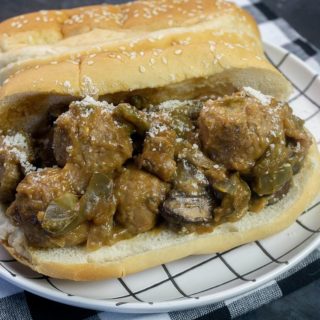 Instant Pot Philly Cheese Steak Meatballs on black with plaid napkin