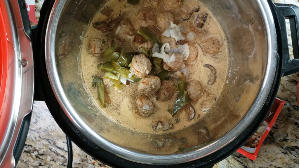 Meatballs in gravy with vegetables inside the instant pot