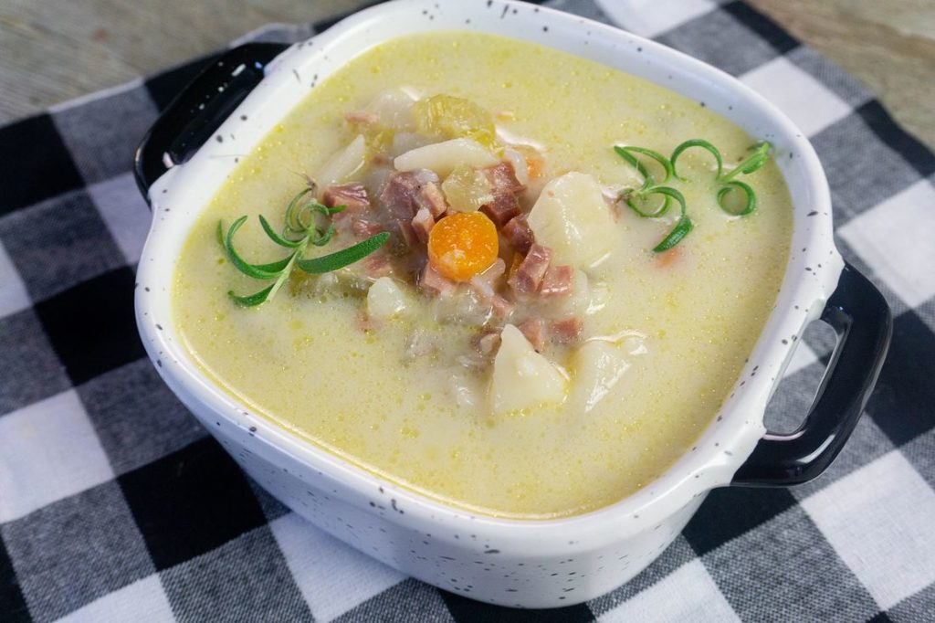 Instant Pot Ham Potato Soup on plaid with wood.