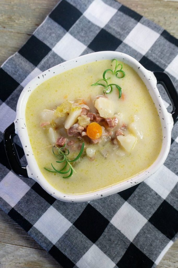 Instant Pot Ham Potato Soup on black plaid napkin and wood board