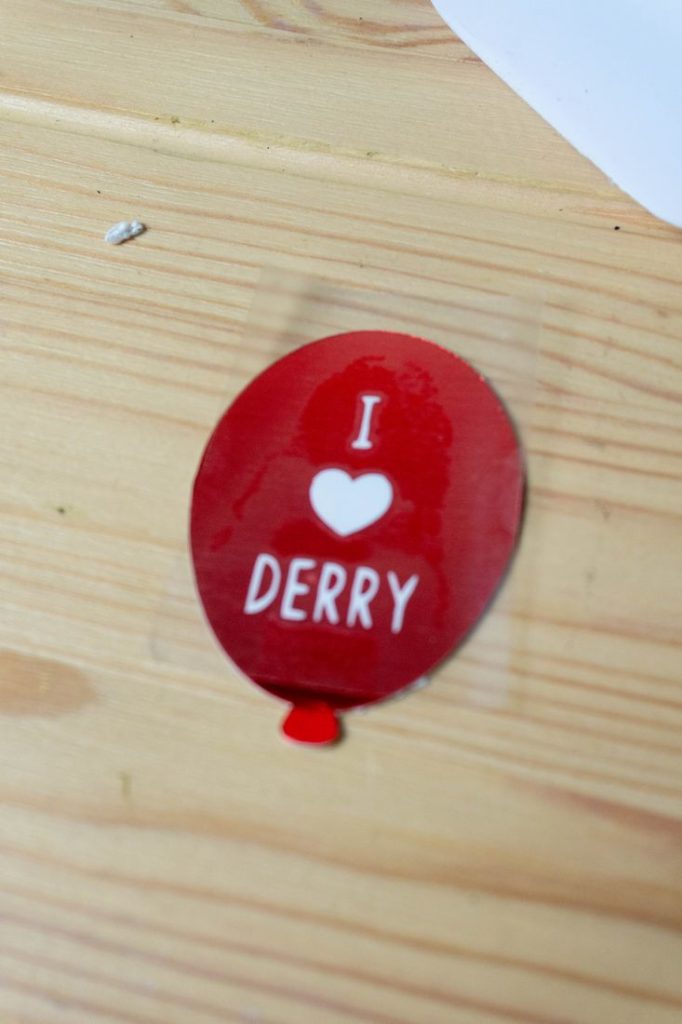Red Balloon on wood that says I Heart Derry