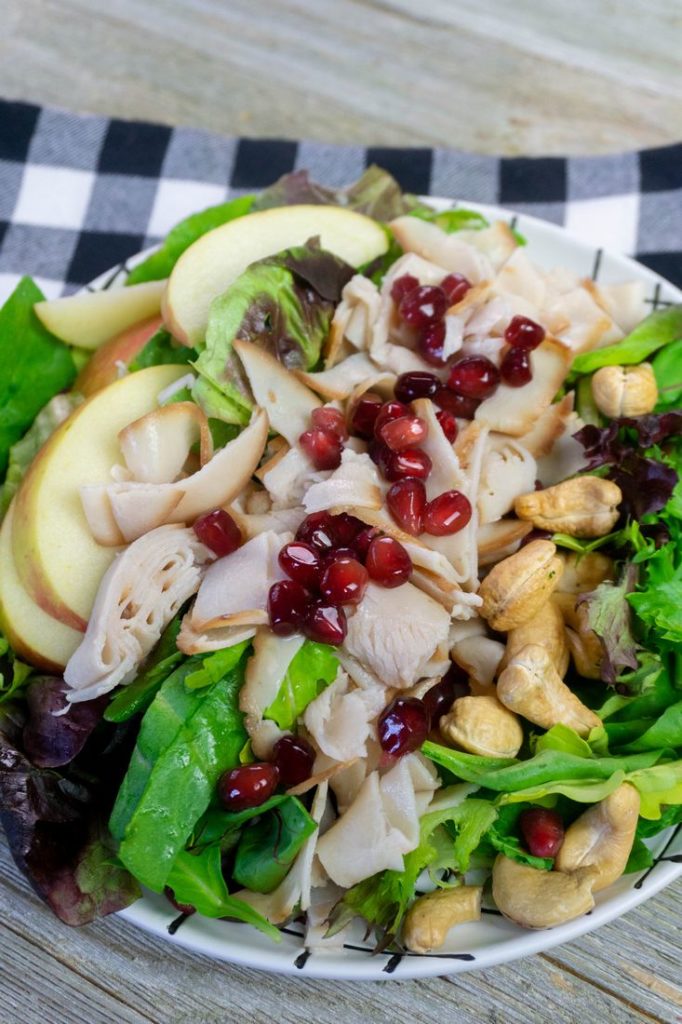 Thanksgiving Fall Harvest Salad on Gray Wood With Plaid Napkin