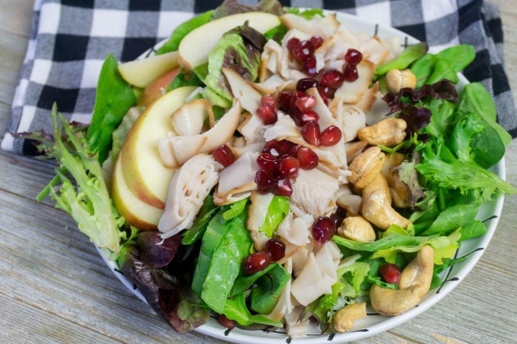 Thanksgiving Fall Harvest Salad on Gray Wood With Plaid Napkin