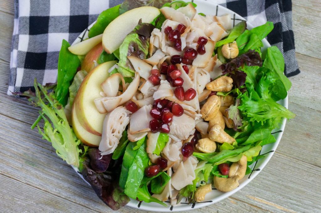 Thanksgiving Fall Harvest Salad on Gray Wood With Plaid Napkin