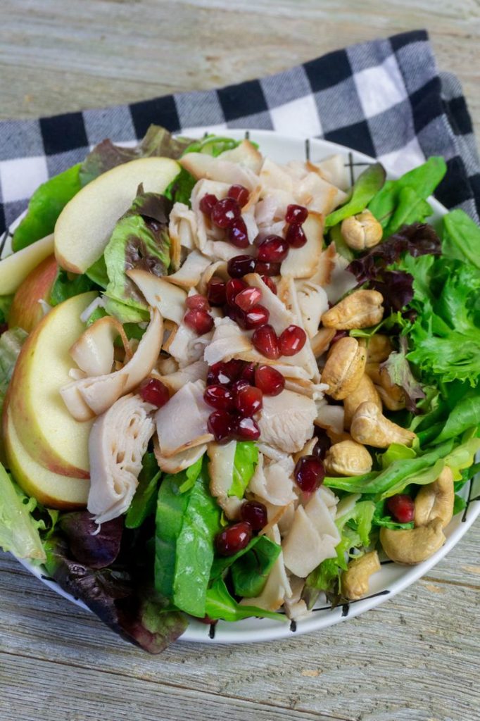 Thanksgiving Fall Harvest Salad on Gray Wood With Plaid Napkin