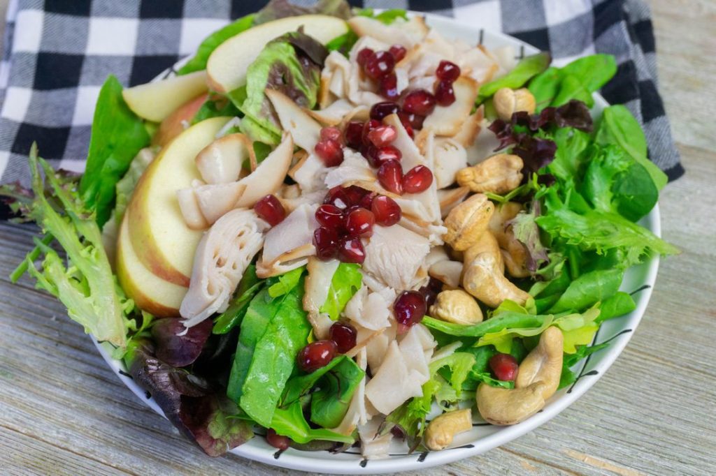 Thanksgiving Fall Harvest Salad on Gray Wood With Plaid Napkin