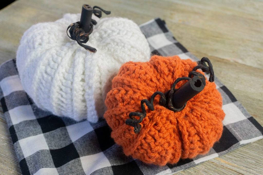 Farmhouse Crochet Pumpkins on plaid and gray wood. 