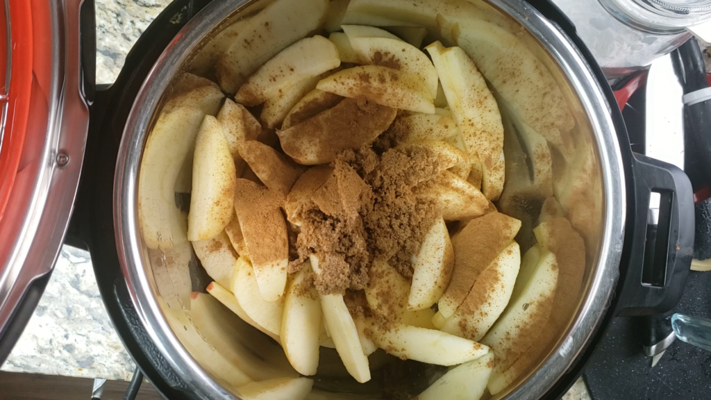 Apples inside the instant pot with cinnamon and sugar