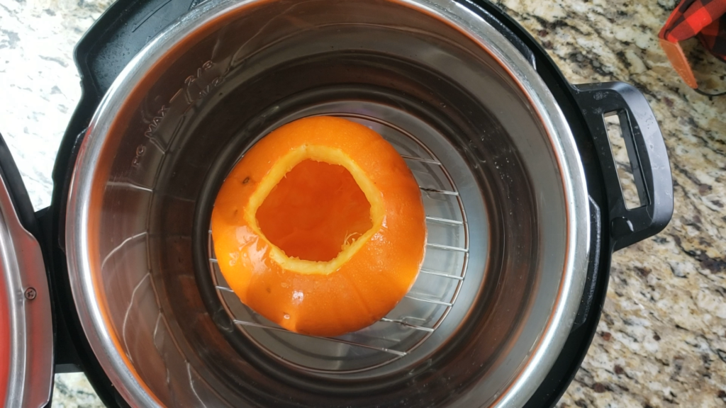 Trivet inside instant pot with water and pumpkin