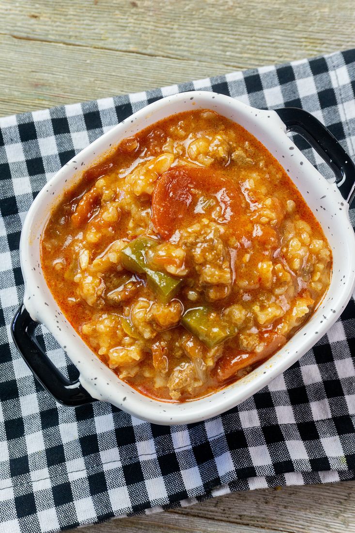 Instant Pot Czech Stuffed Pepper Soup in a black and white bowl on a black and white plaid napkin