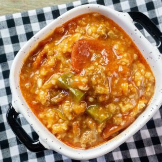 Instant Pot Czech Stuffed Pepper Soup in a black and white bowl on a black and white plaid napkin