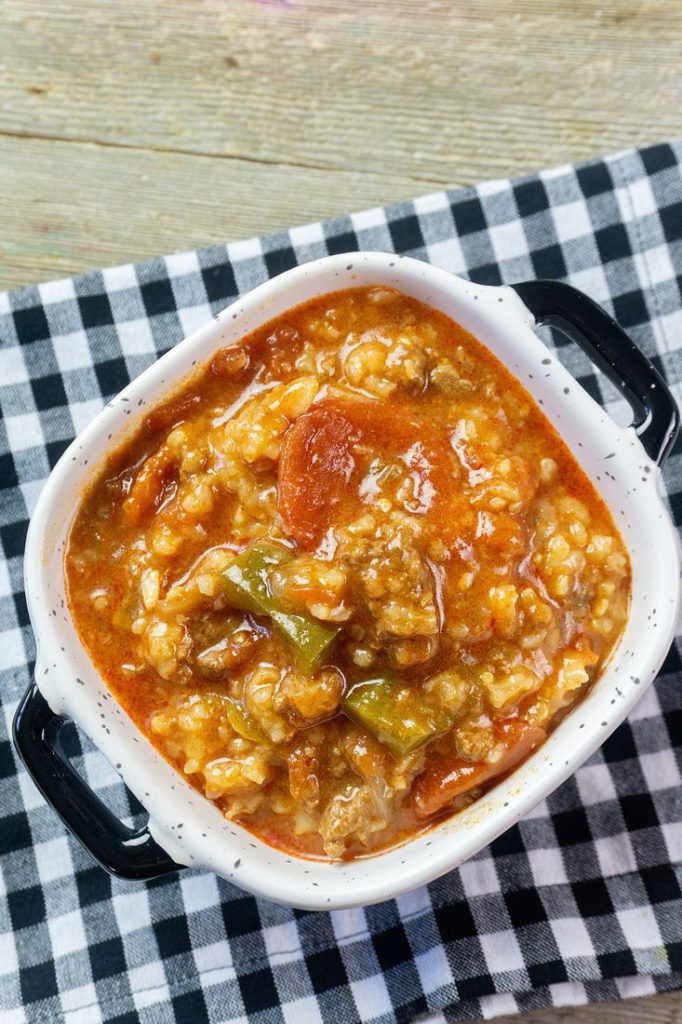 Instant Pot Czech Stuffed Pepper Soup in a black and white bowl on a black and white plaid napkin