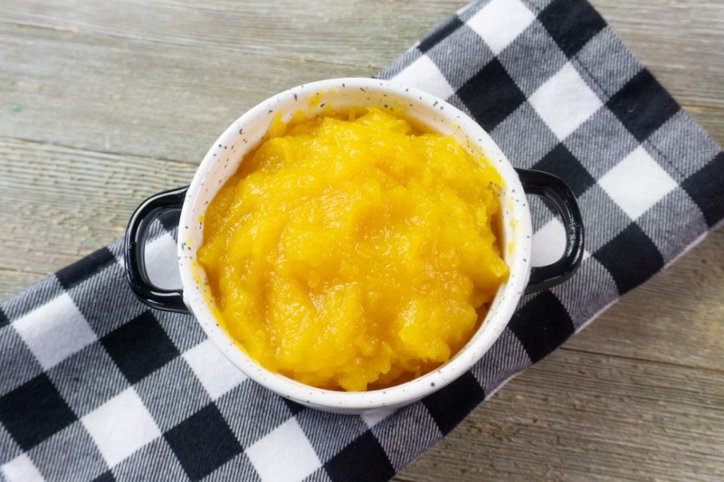 Instant Pot Pumpkin Puree in a white bowl with plaid napkin