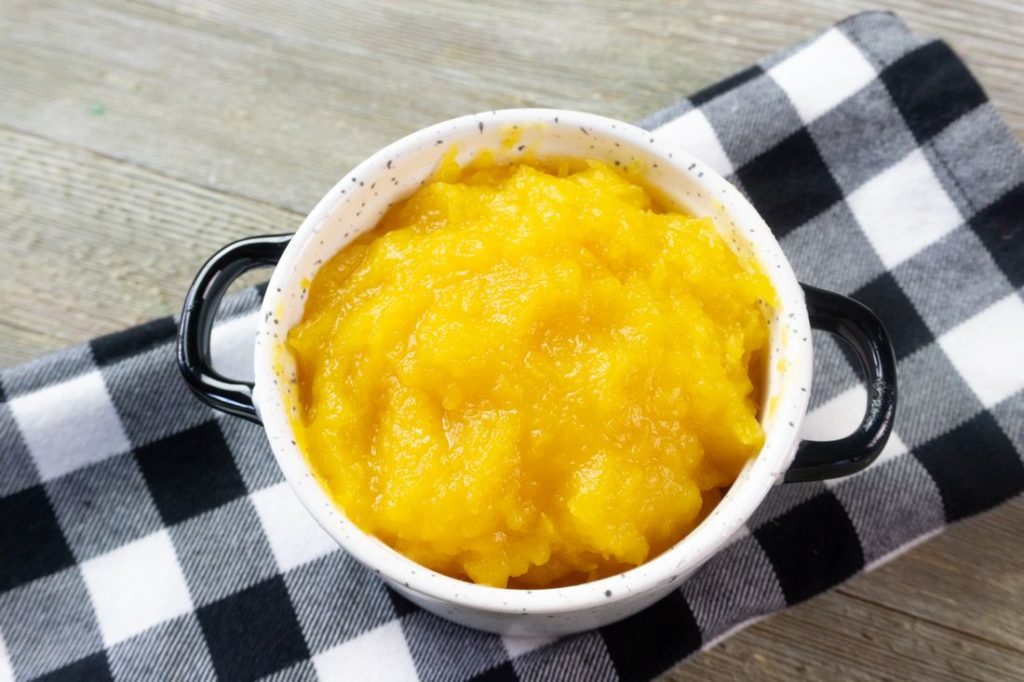 Instant Pot Pumpkin Puree in a white bowl with plaid napkin