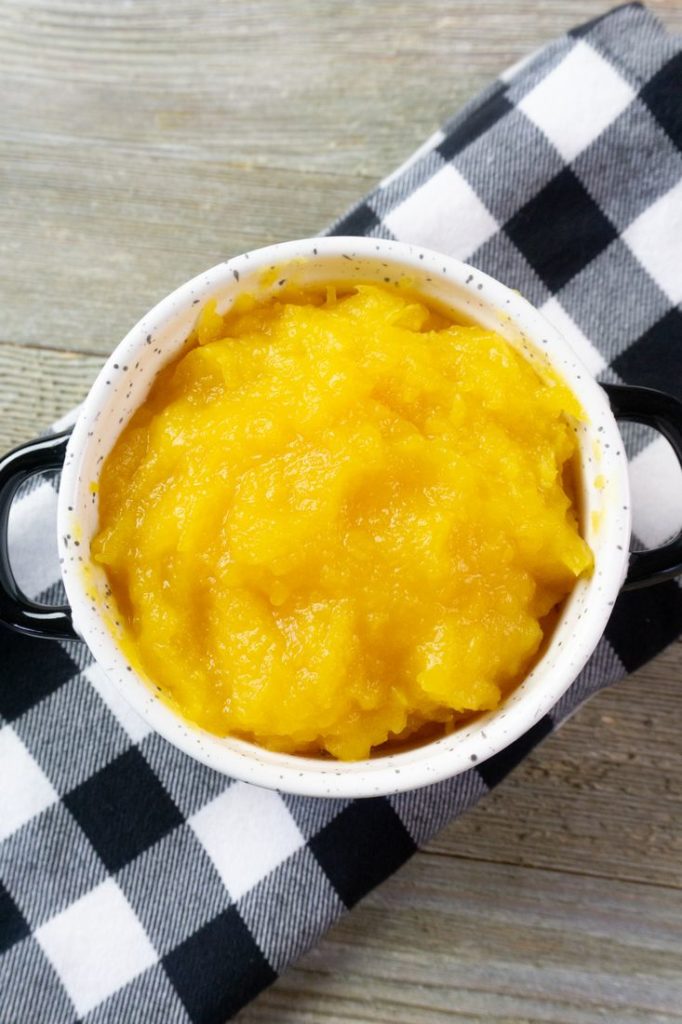 Instant Pot Pumpkin Puree in a white bowl with plaid napkin