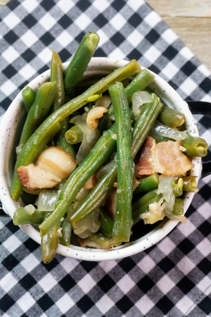 Instant Pot Bacon Green Beans inside a black and white bowl on a plaid napkin