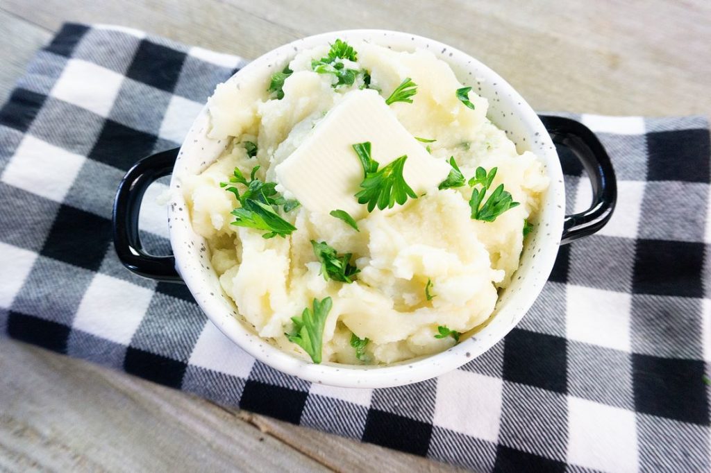 Instant Pot Garlic Parmesan Mashed Potatoes on gray wood with plaid napkin