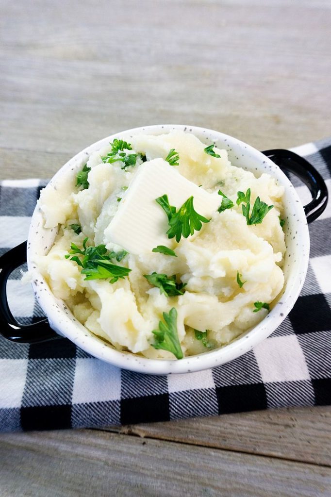 Instant Pot Garlic Parmesan Mashed Potatoes on gray wood with plaid napkin