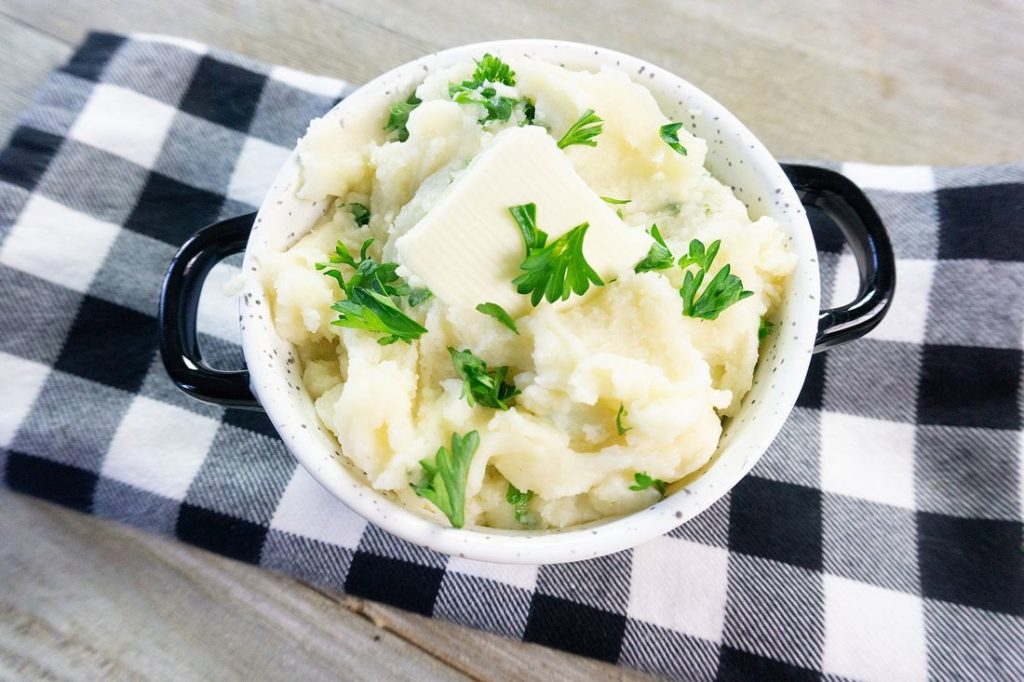 Instant Pot Garlic Parmesan Mashed Potatoes on gray wood with plaid napkin