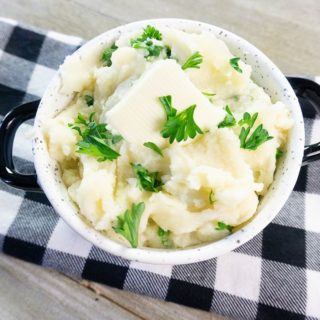 Instant Pot Garlic Parmesan Mashed Potatoes on gray wood with plaid napkin