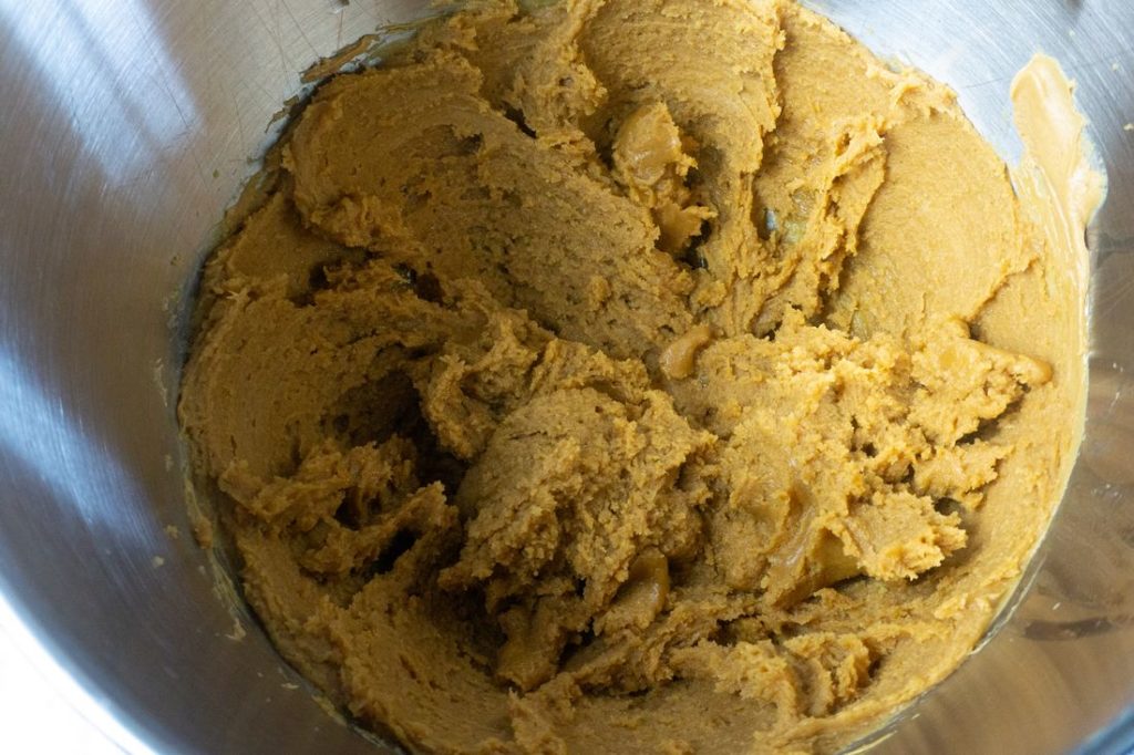 Peanut butter cookie mixture inside the kitchen aid bowl