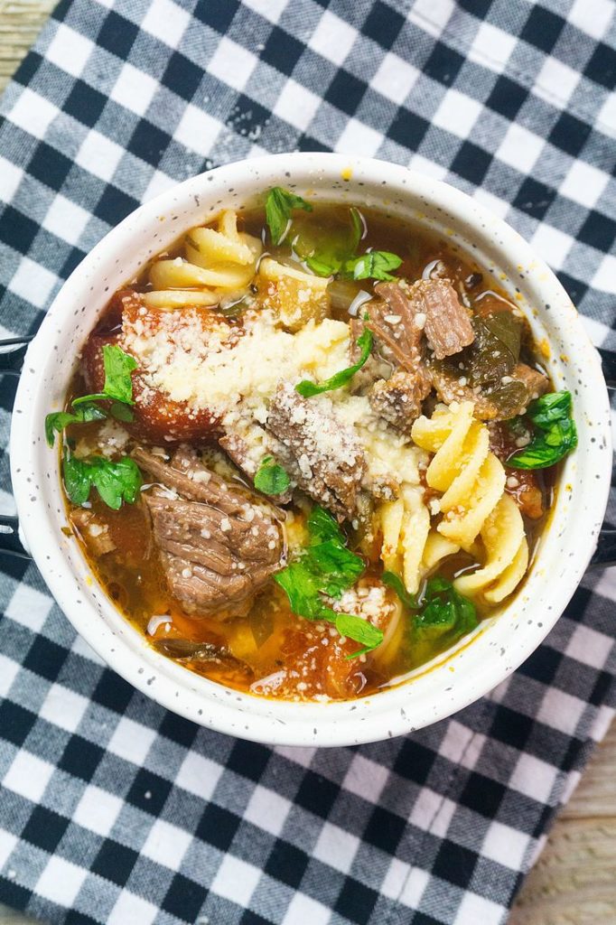 Instant Pot Beef Parmesan Soup on buffalo plaid napkin and gray wood surface