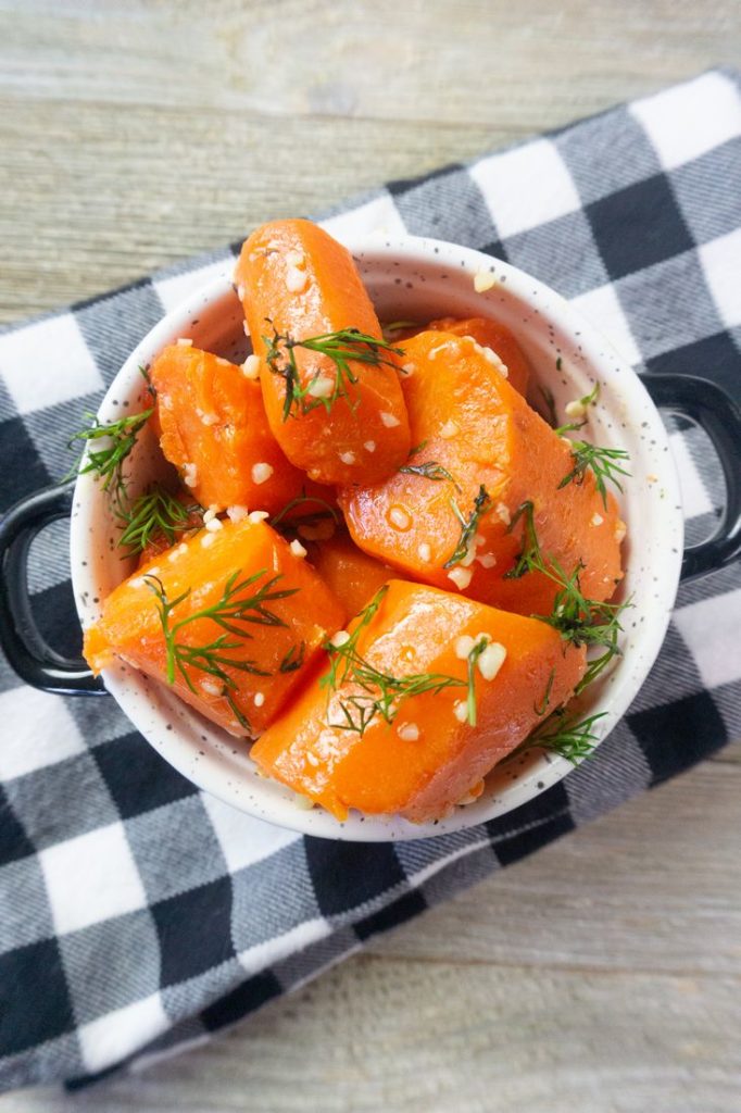 Instant Pot Garlic Dill Carrots on grey wood in a white bowl