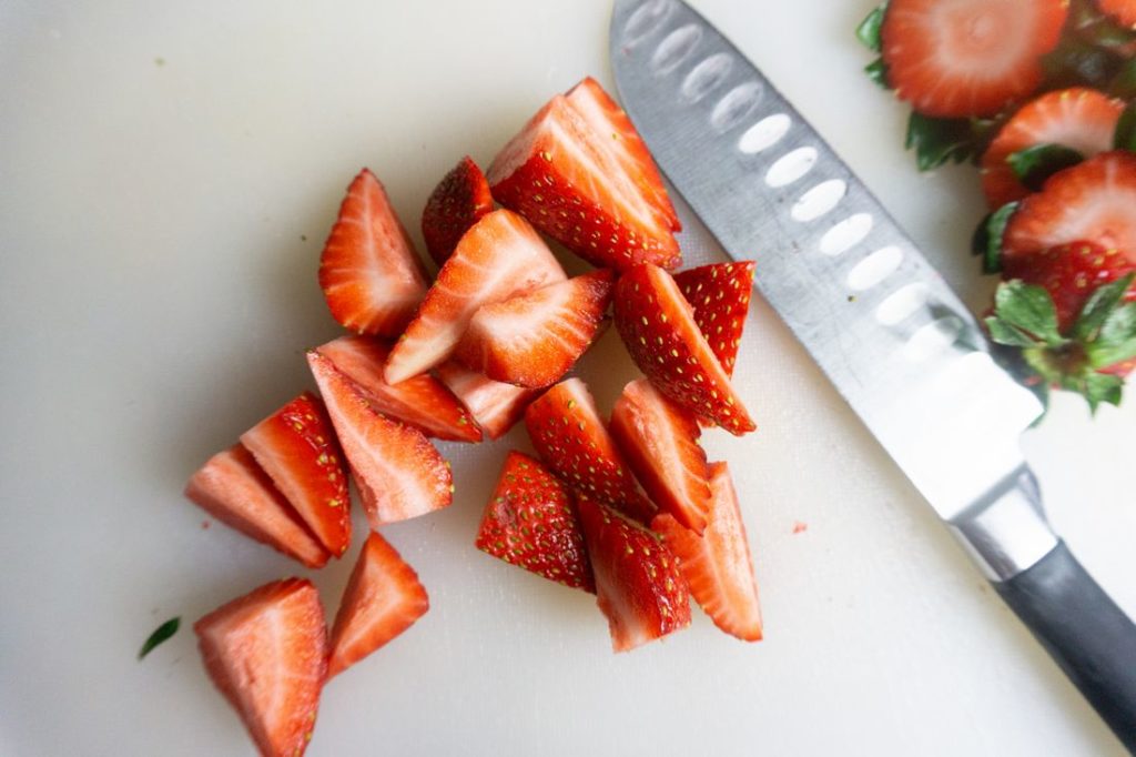 Strawberries sliced on a cutting board