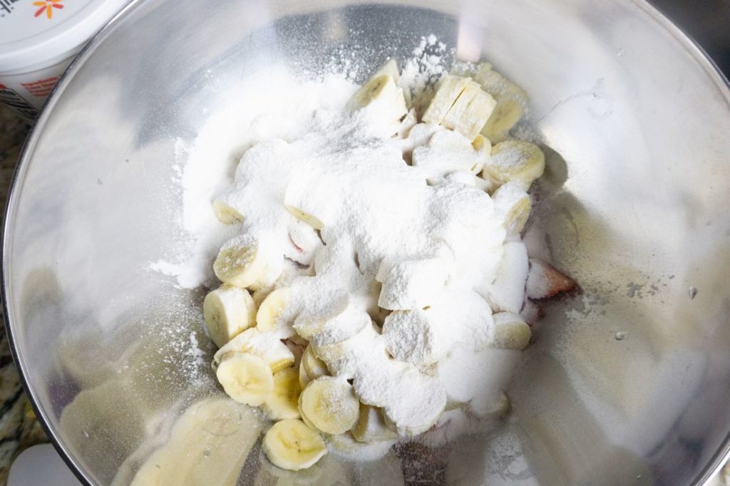 Strawberries, Bananas, and pudding mix in a large metal bowl