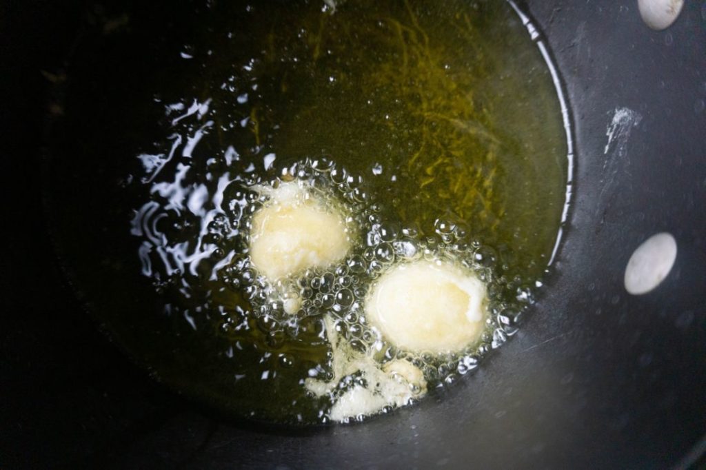 Bananas with pancake batter in hot oil