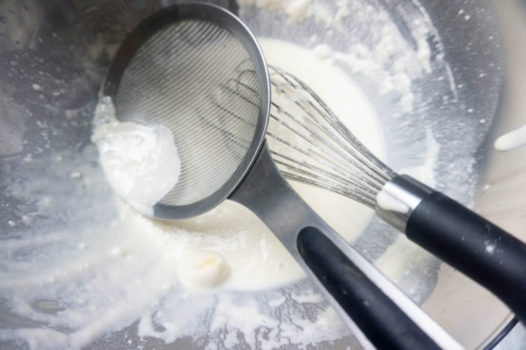 Spider and tongs in pancake batter