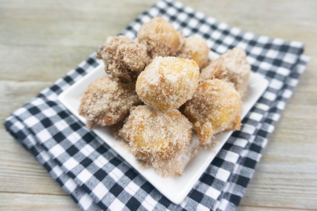 Deep Fried Bananas on a small white late with black and white plaid napkin