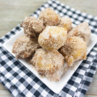 Deep Fried Bananas on a small white late with black and white plaid napkin